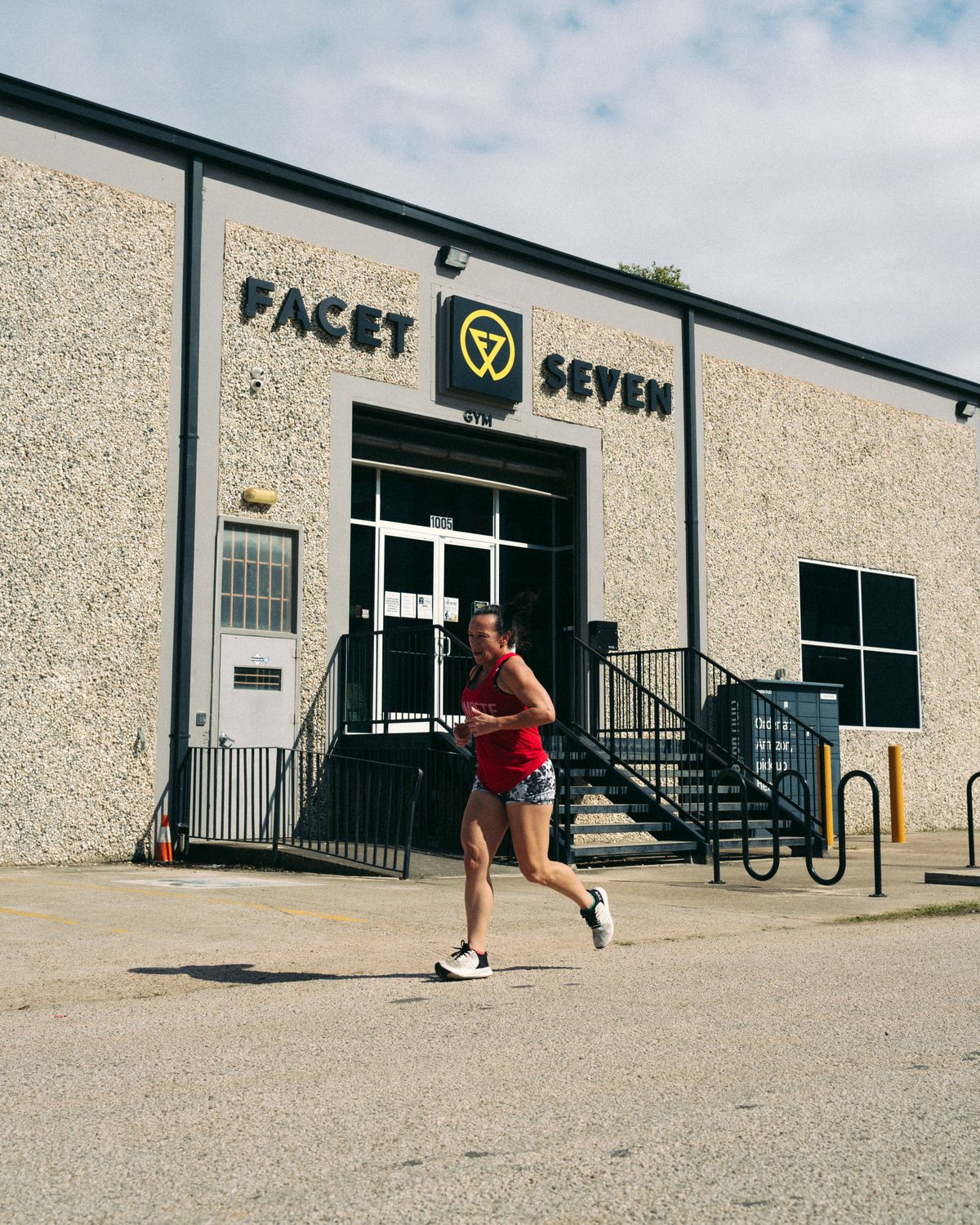 Facet Seven member running past the Facet Seven gym