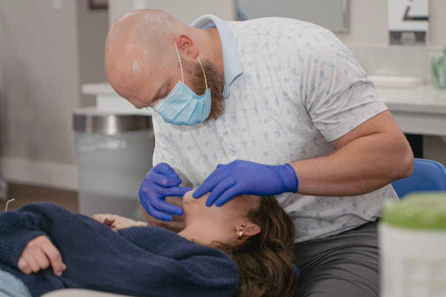Orthodontist examining a young patient during an orthodontic appointment at an Idaho orthodontic office.