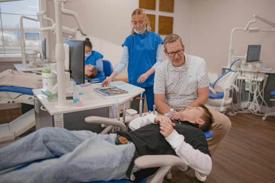 Orthodontist and clinical team caring for a young patient during an orthodontic appointment at an Idaho Falls orthodontic office.