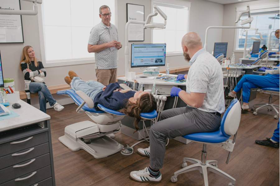 Idaho Orthodontics team providing orthodontic care to a patient in a bright, modern treatment area.