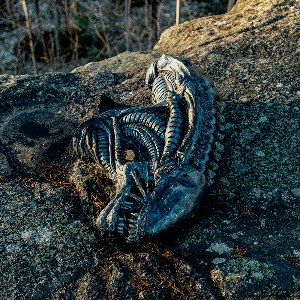 Three persons sitting on a sofa with masks over their faces