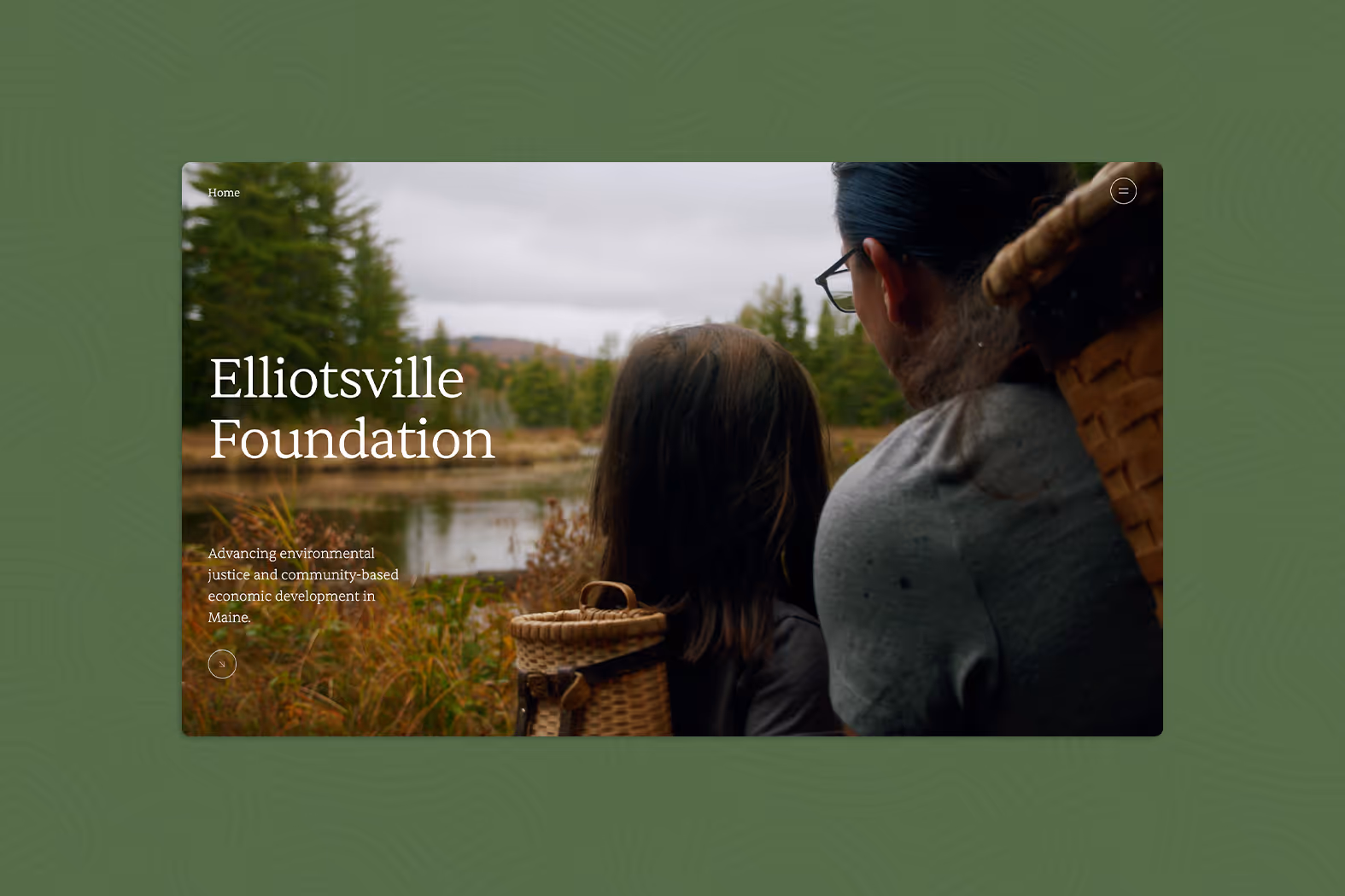 Two people with woven backpacks looking at a pond surrounded by trees under a cloudy sky.