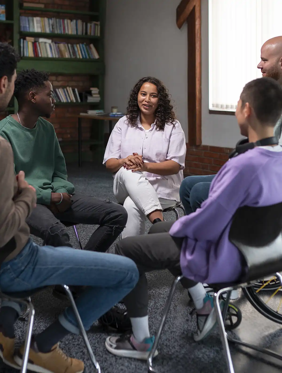 A small group sitting in a circle during a discussion