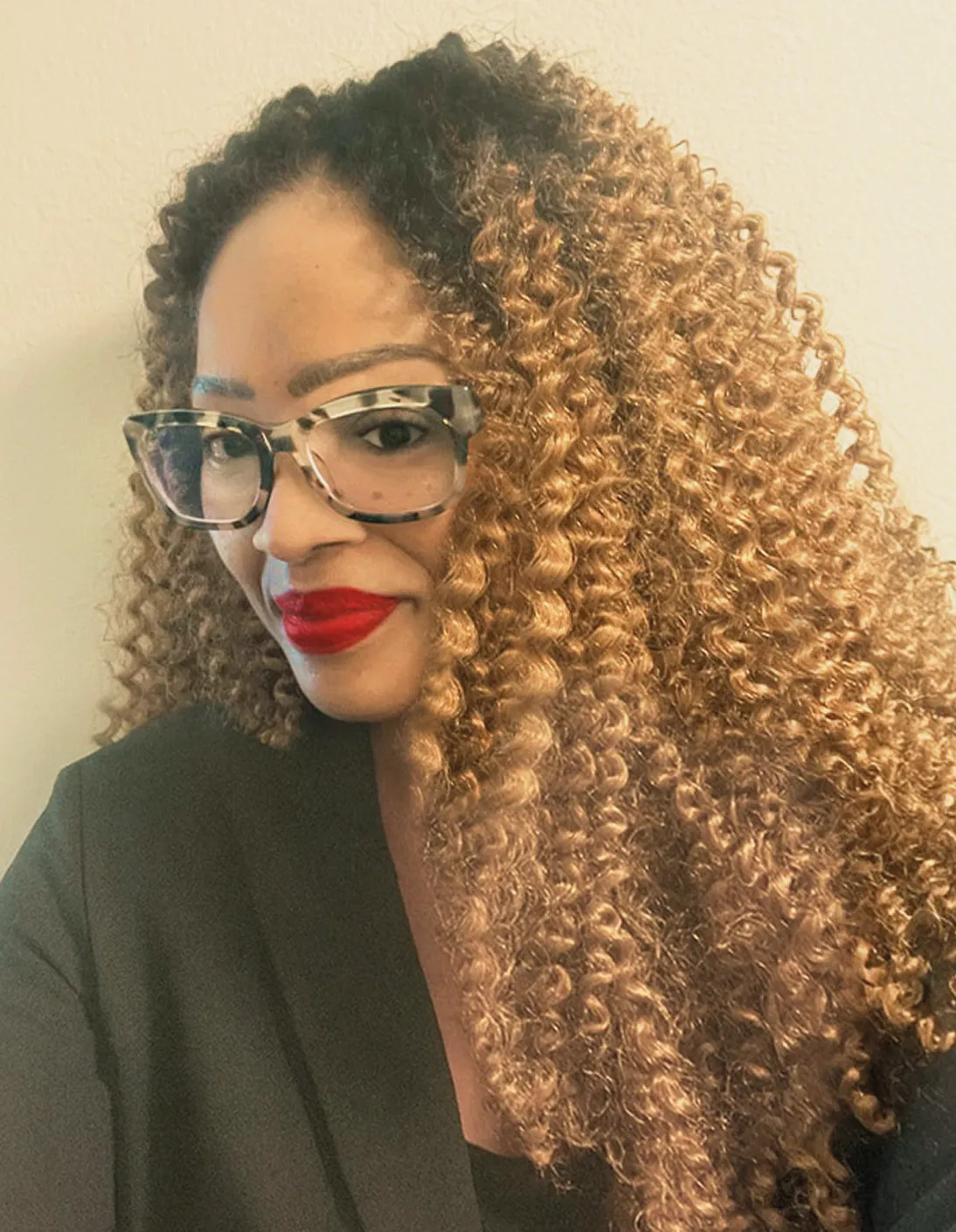 A headshot of Stephanie in glasses