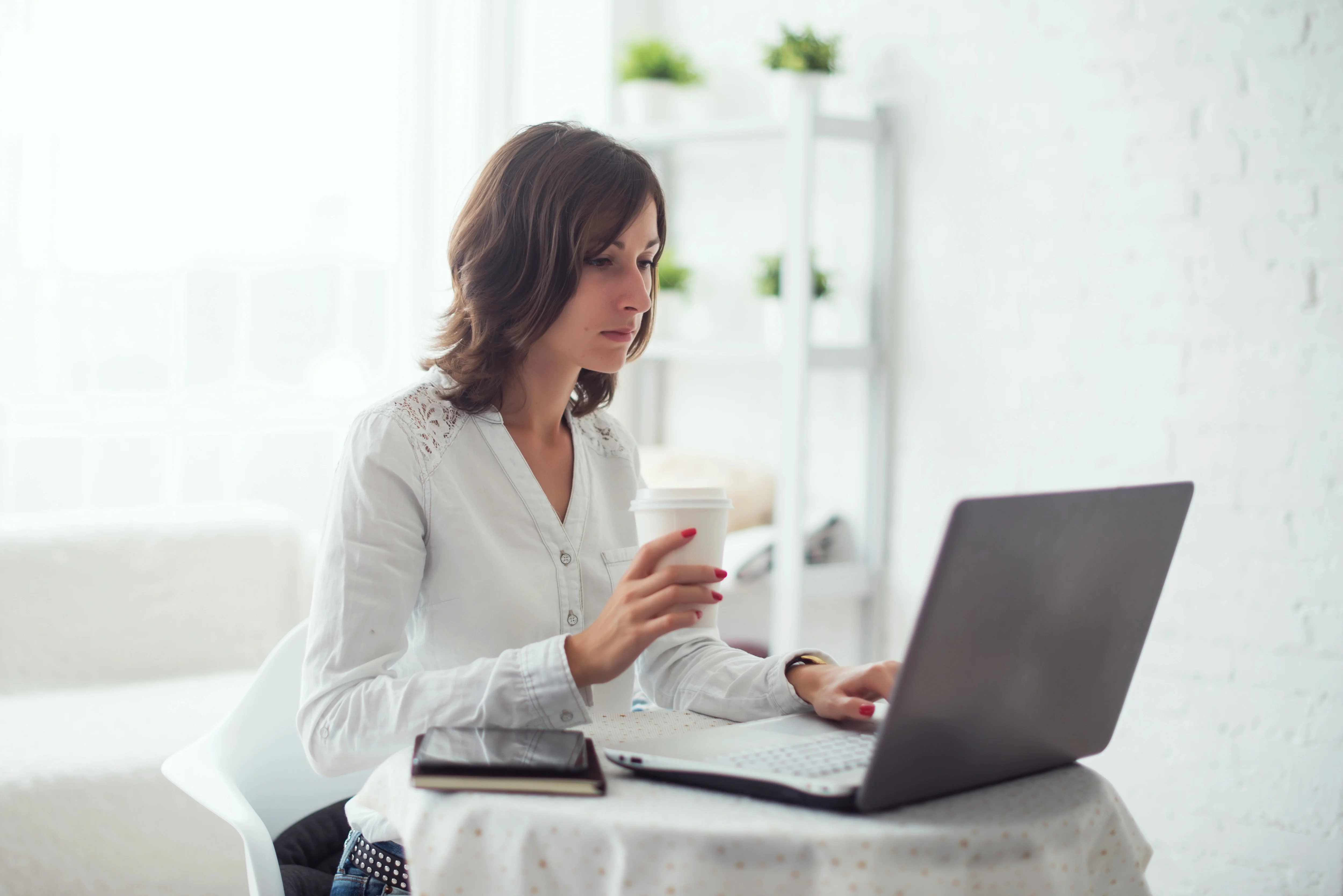 business woman sitting at desk and using laptop computer to learn about UX mistakes in ecommerce