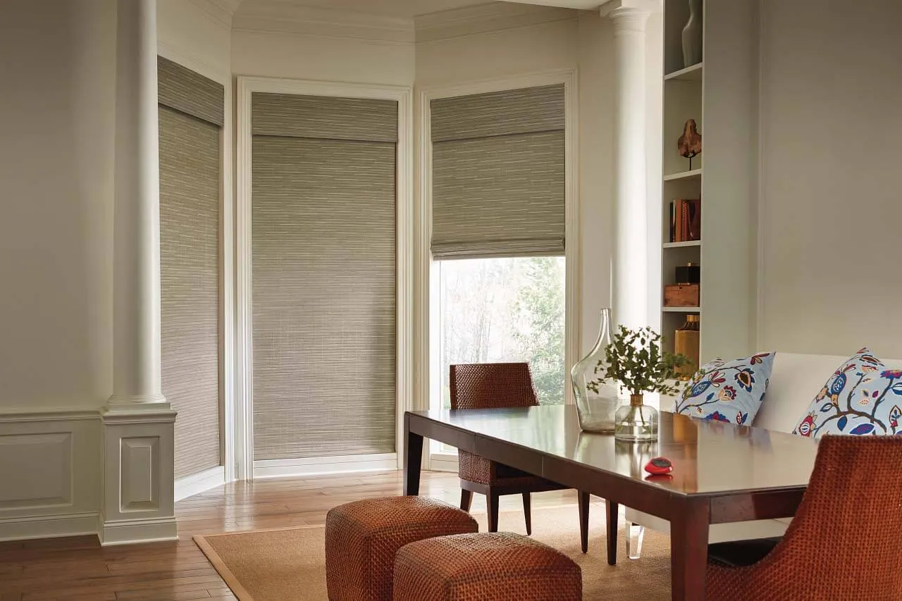 Bamboo blinds on loft windows behind a white sofa.