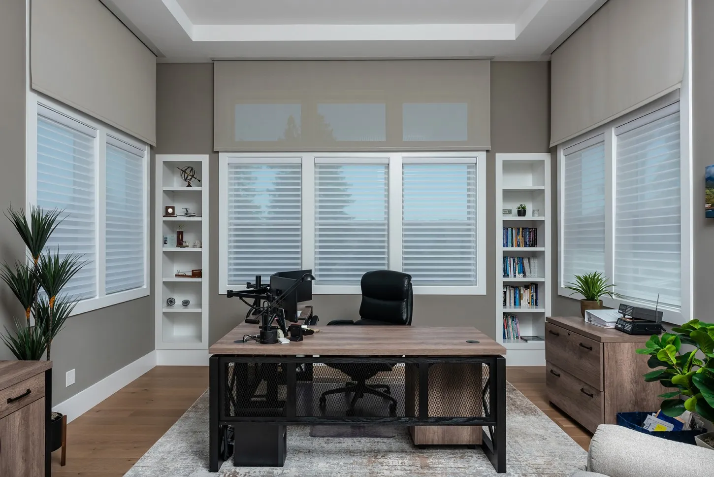 Motorized interior window coverings in a home office.