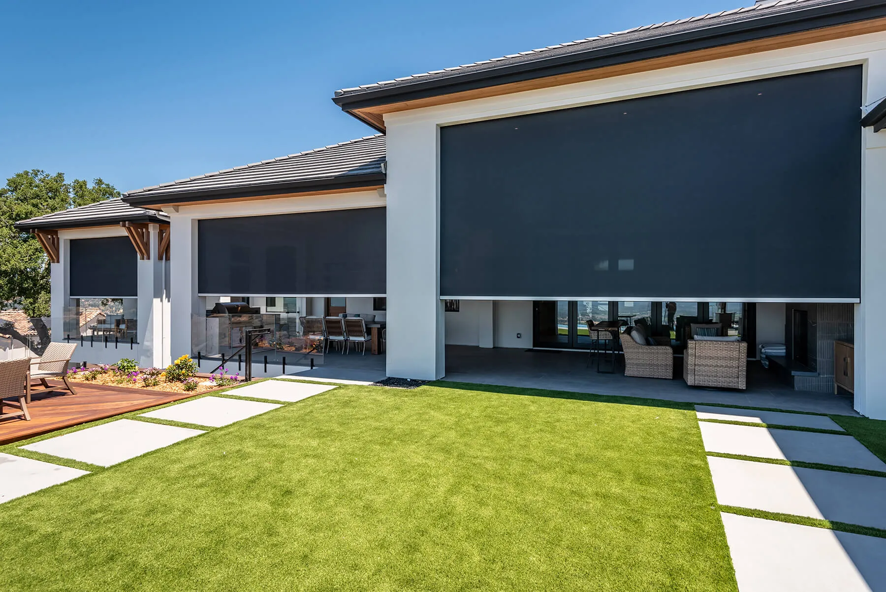 Motorized exterior shades on a home exterior.