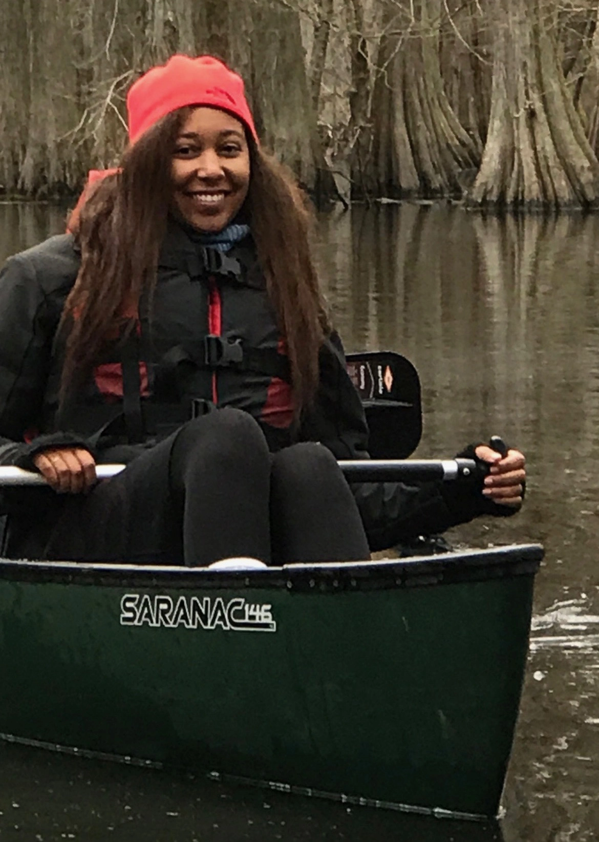 Woman paddling in a canoe