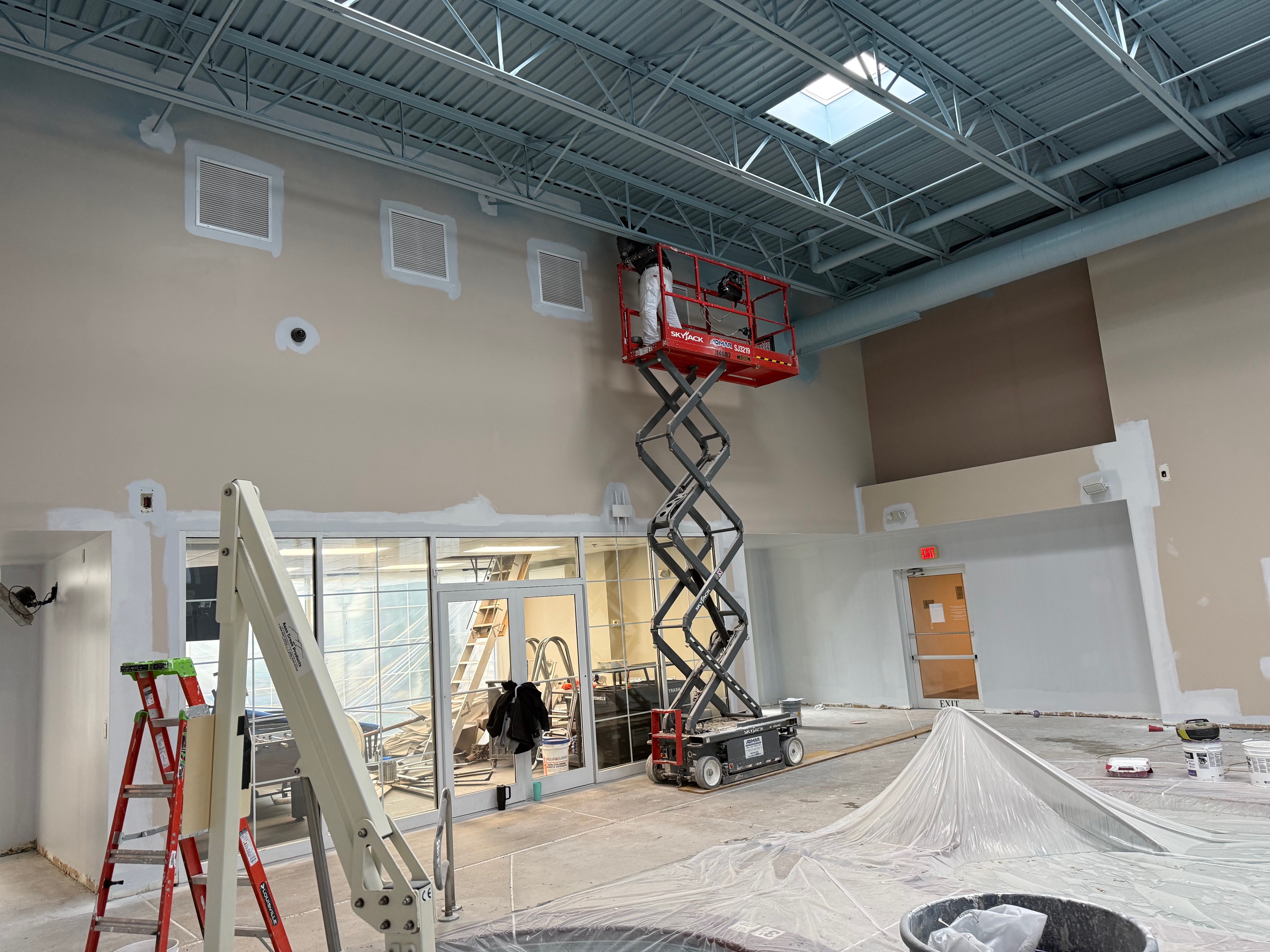Interior pool area wall prep with scissor lift in use at Homewood Suites Cheektowaga