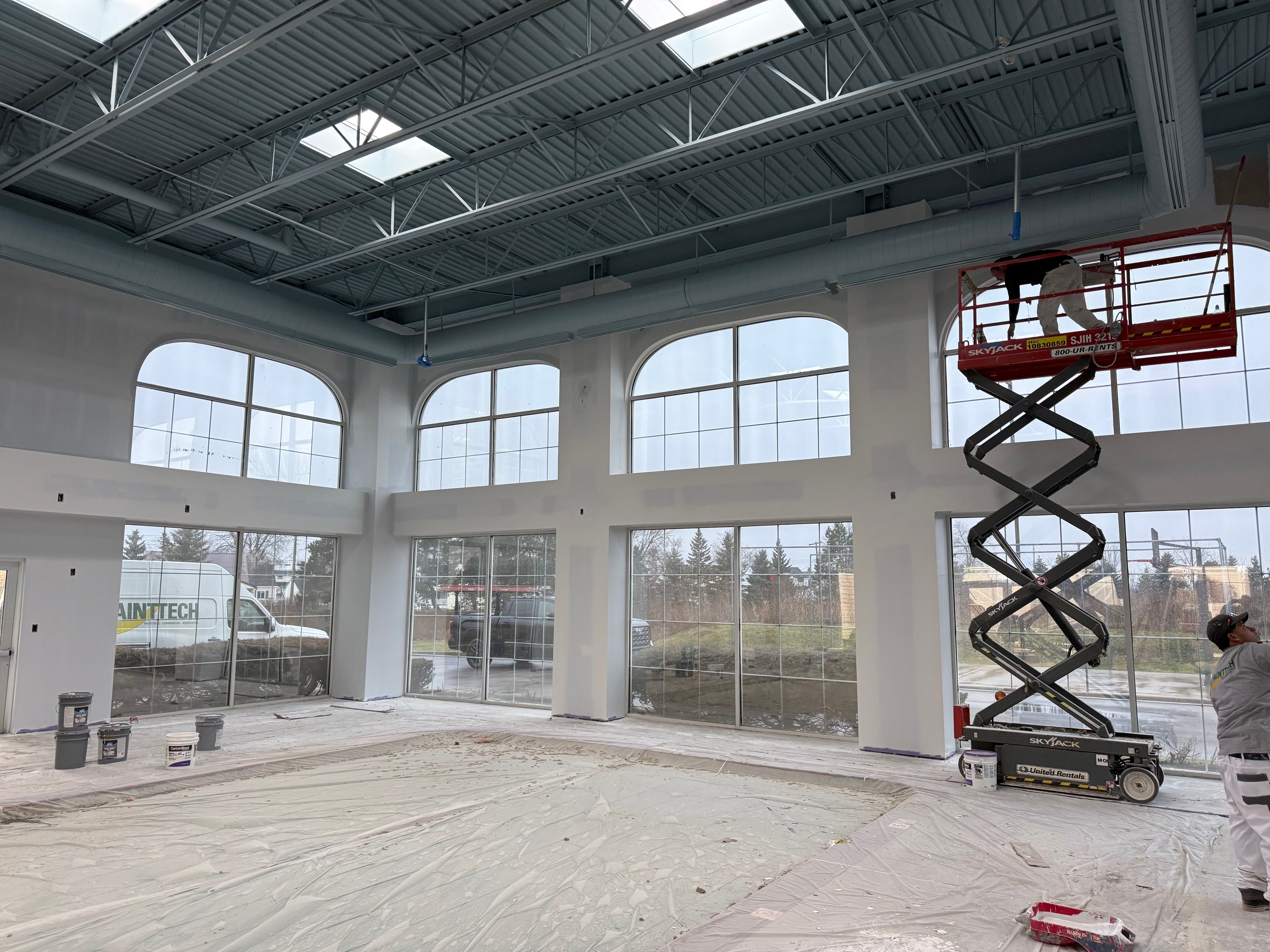 In-progress repainting of pool room at Homewood Suites, with bright new wall color and skylights above