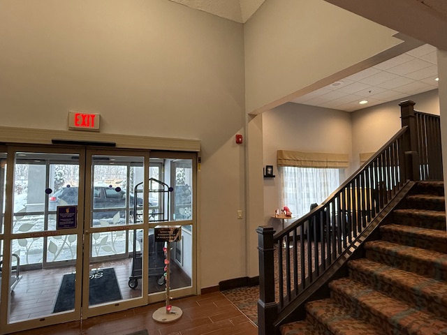 Entryway of Sleep Inn after interior repaint with neutral tones, updated walls, and natural lighting