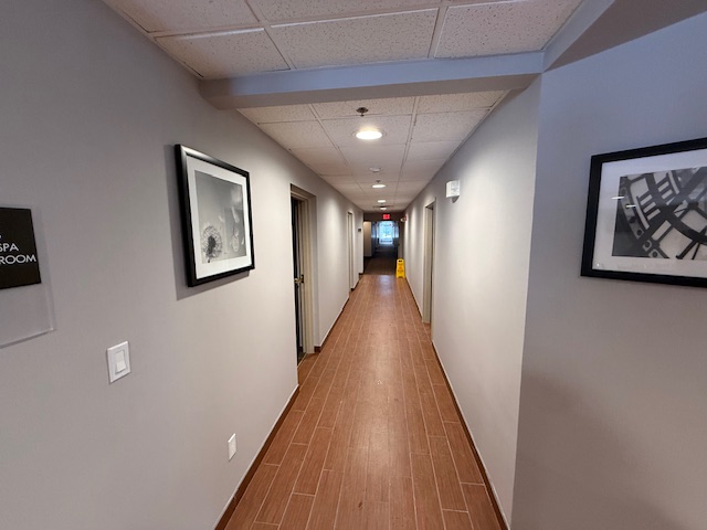 Hotel corridor at Sleep Inn after renovation with updated wall finishes, trim, and improved lighting.