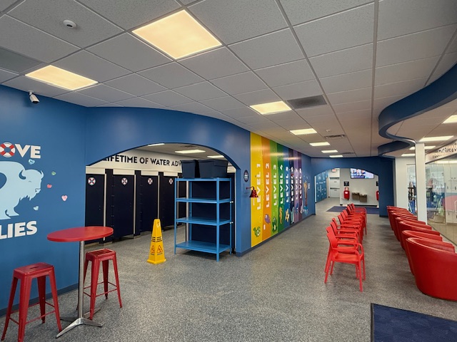 Colorful interior wall with cubbies and seating at Aqua-Tots Swim School in Amherst, NY