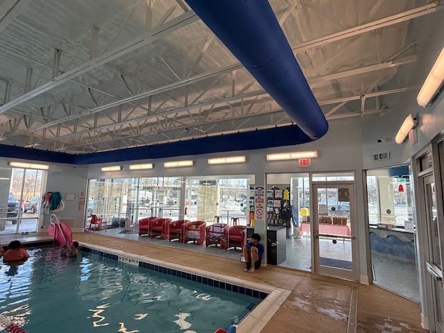 Pool deck and windows at Aqua-Tots Amherst, showing repainted ceilings and bright space.