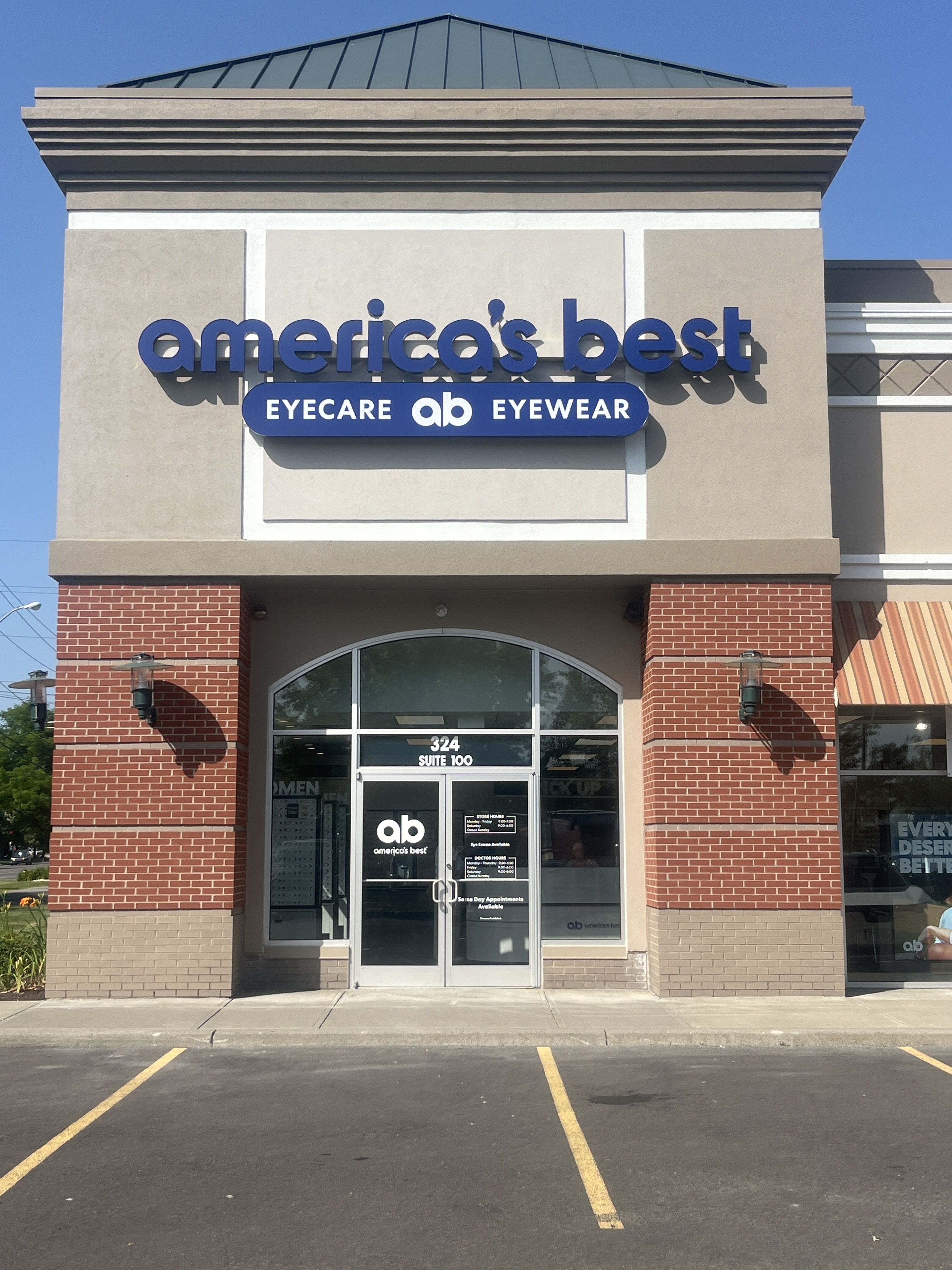 Freshly painted EIFS facade, cornice, and coping at America's Best storefront in Ithaca, NY