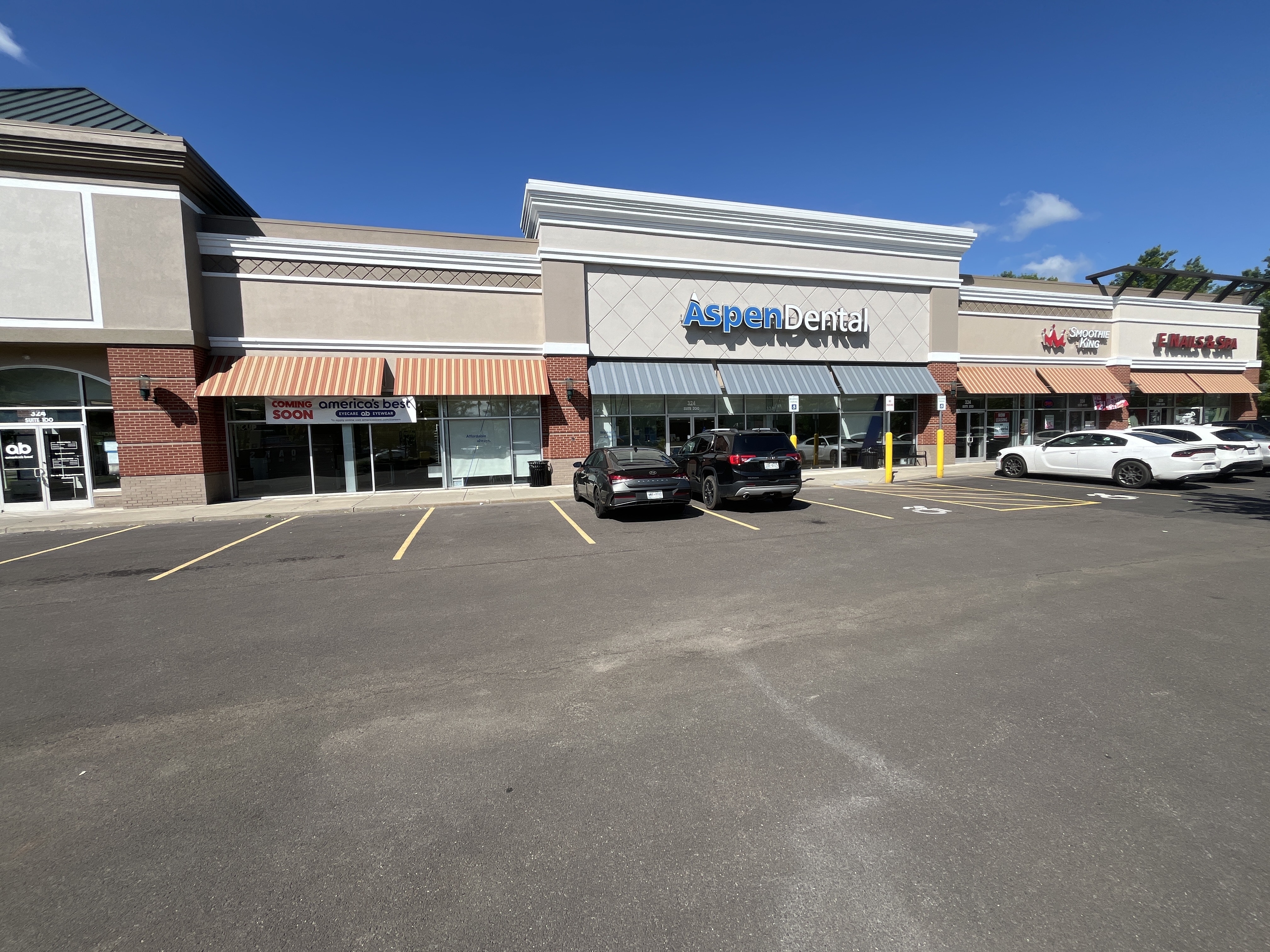 Completed commercial exterior painting project across the front of a retail plaza on Elmira Road in Ithaca, NY