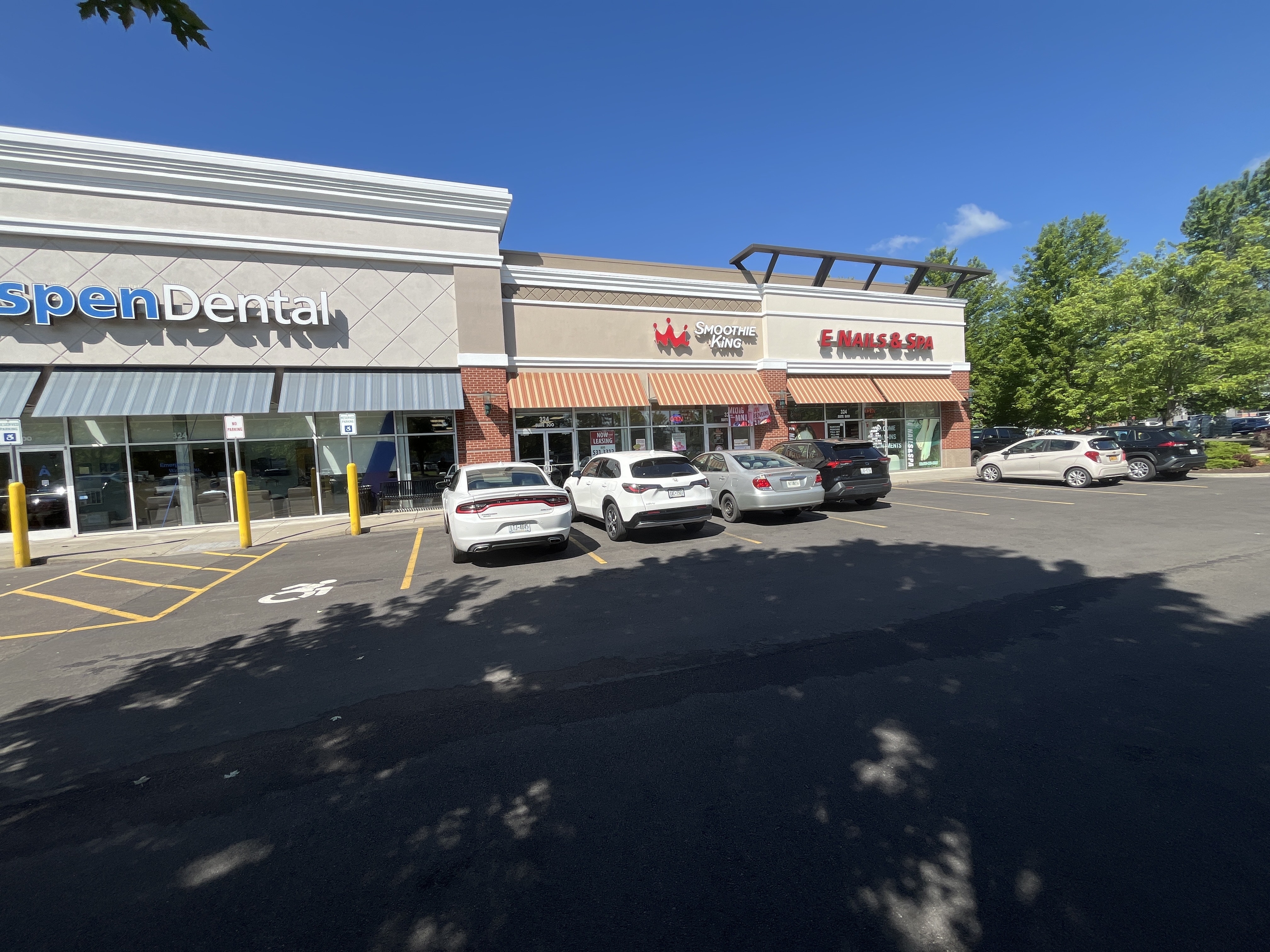 Commercial EIFS painting and storefront facade restoration at Ithaca retail shopping center.