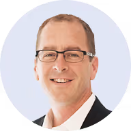 a man wearing glasses and a suit