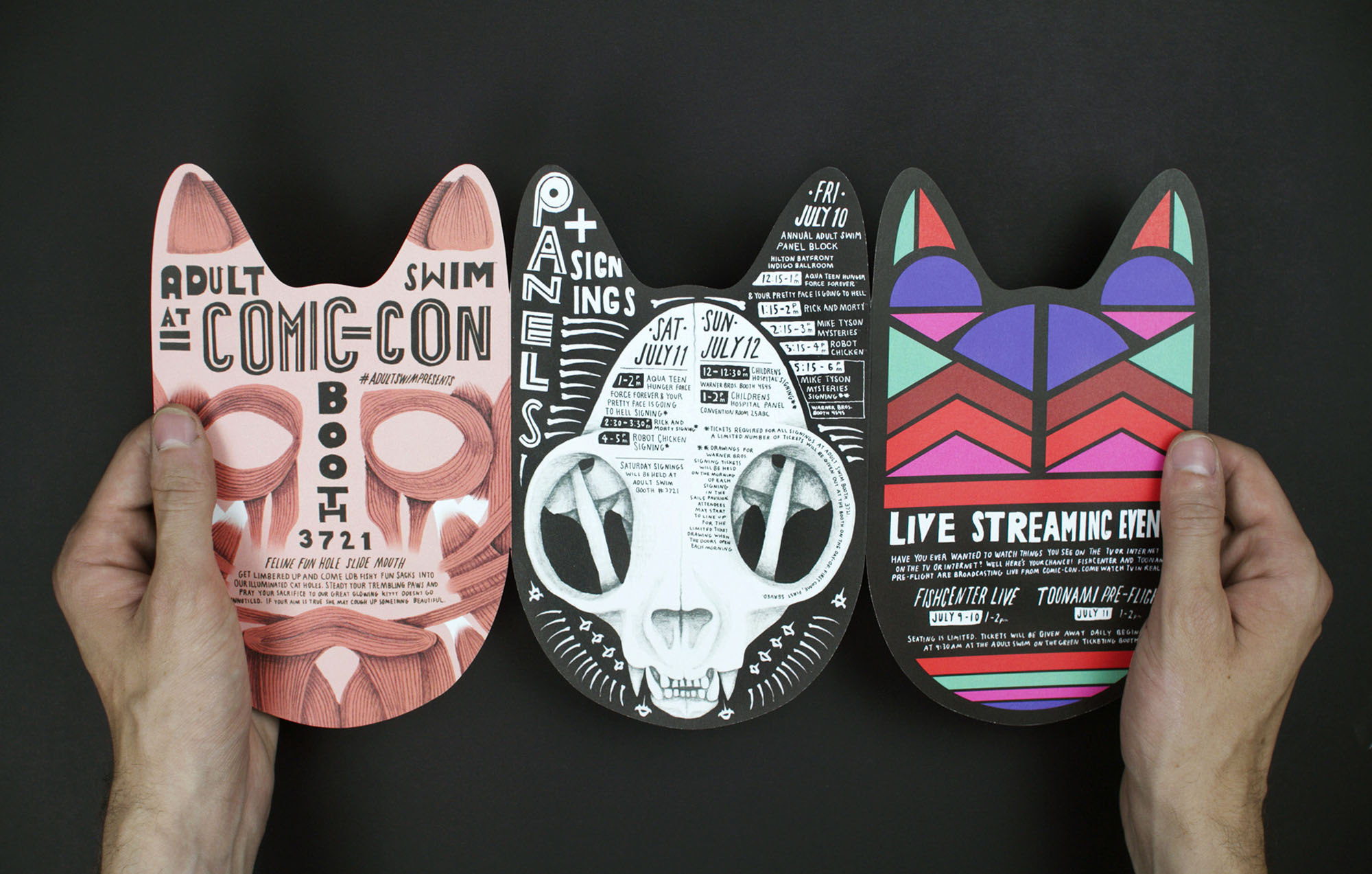 two hands holding a card with a cut out in a cat shape with three sides