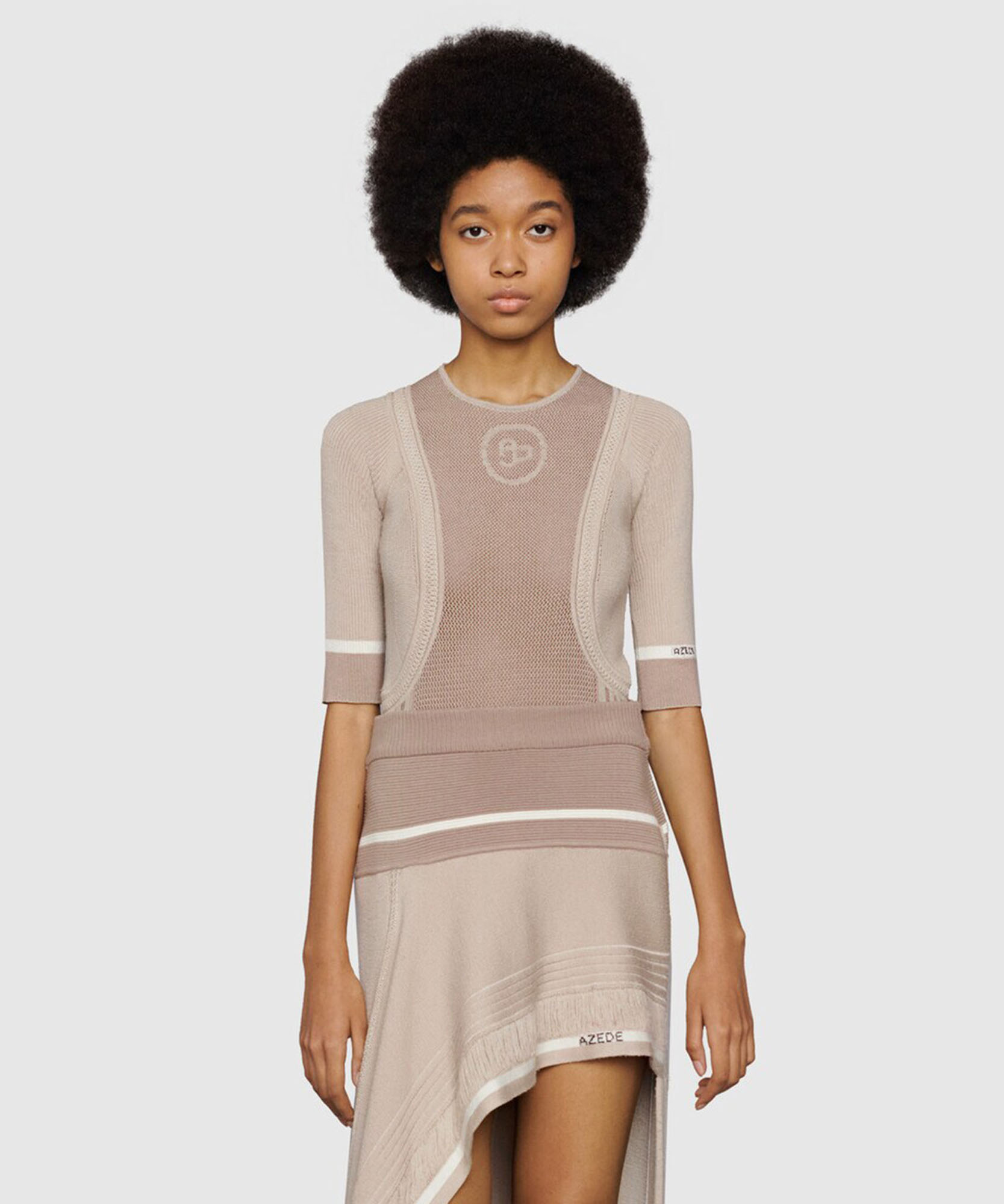 a photo of a women wearing a brown top and skirt with a white background