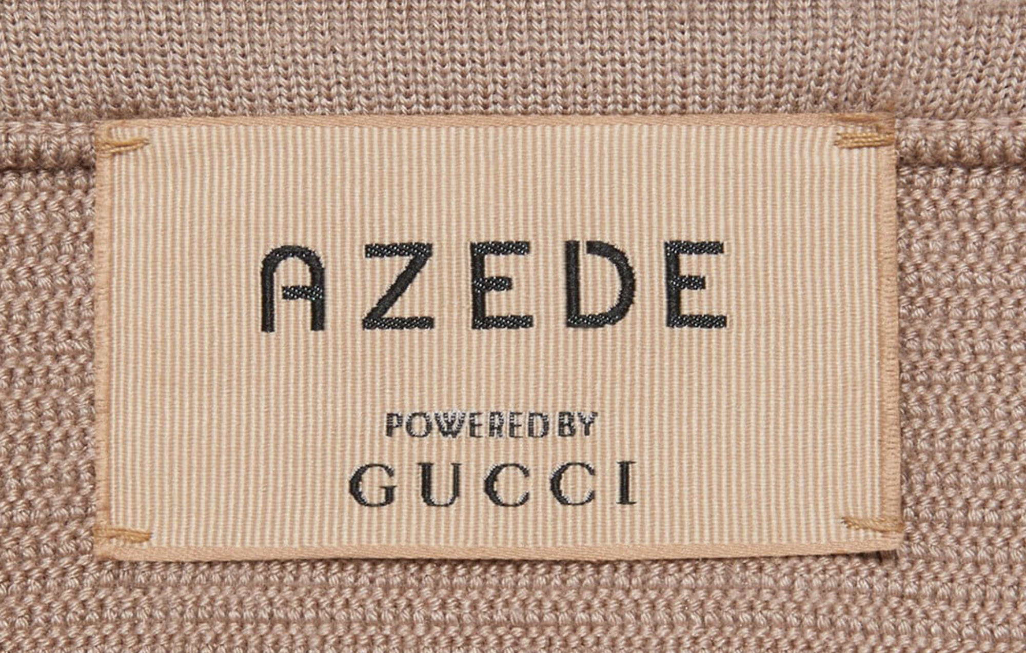 clothing tag with azede and gucci logo