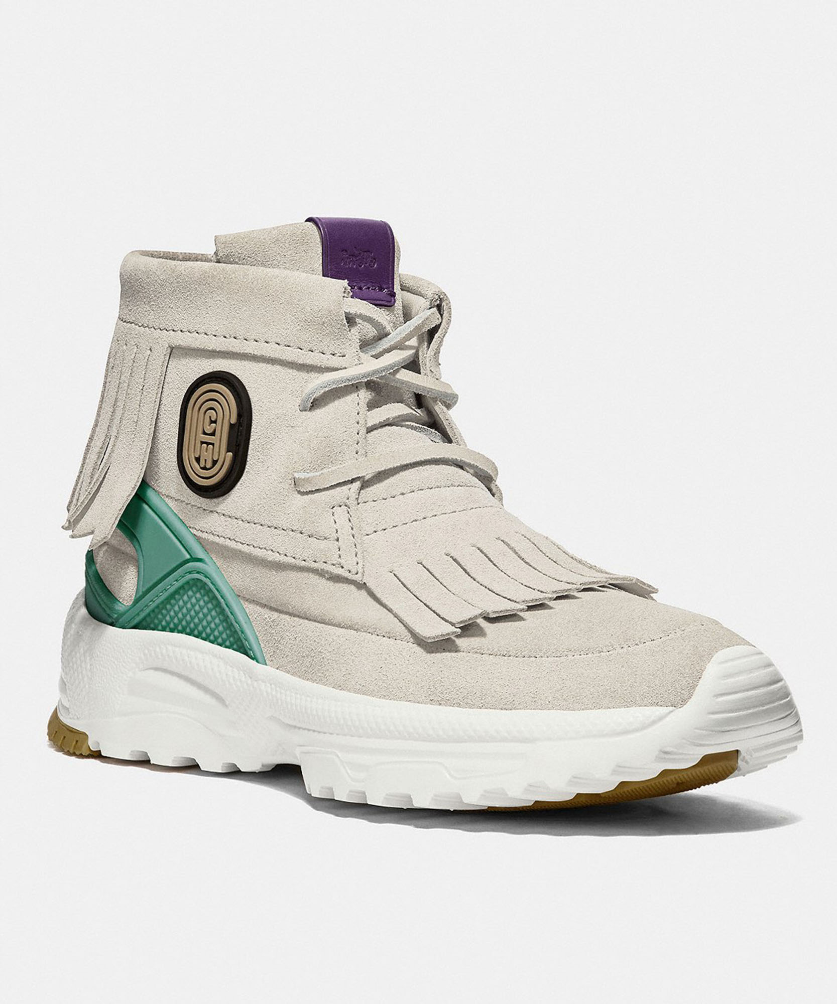a photo of a white shoe with a coach logo