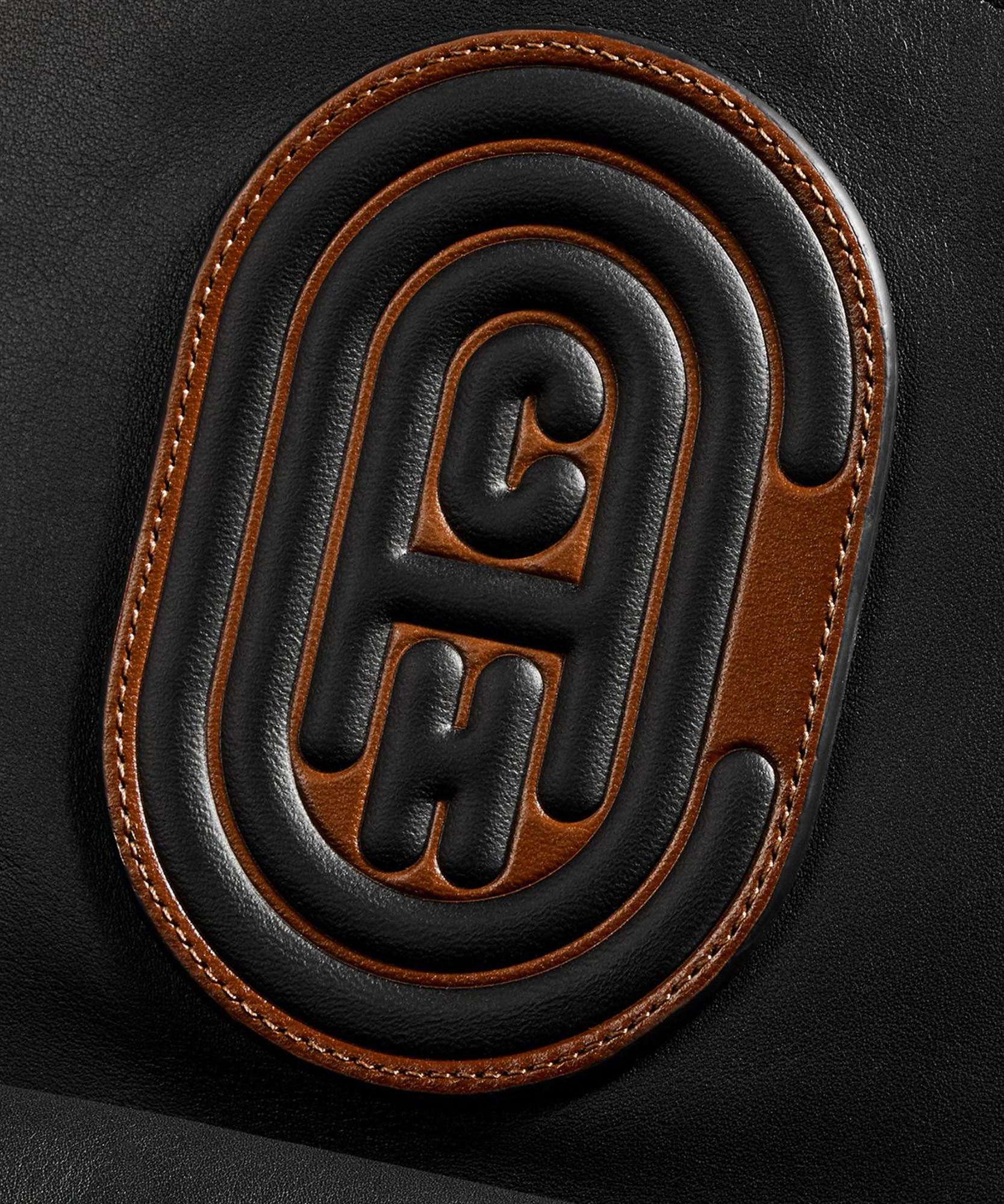 photo of black leather with coach logo imprinted on it