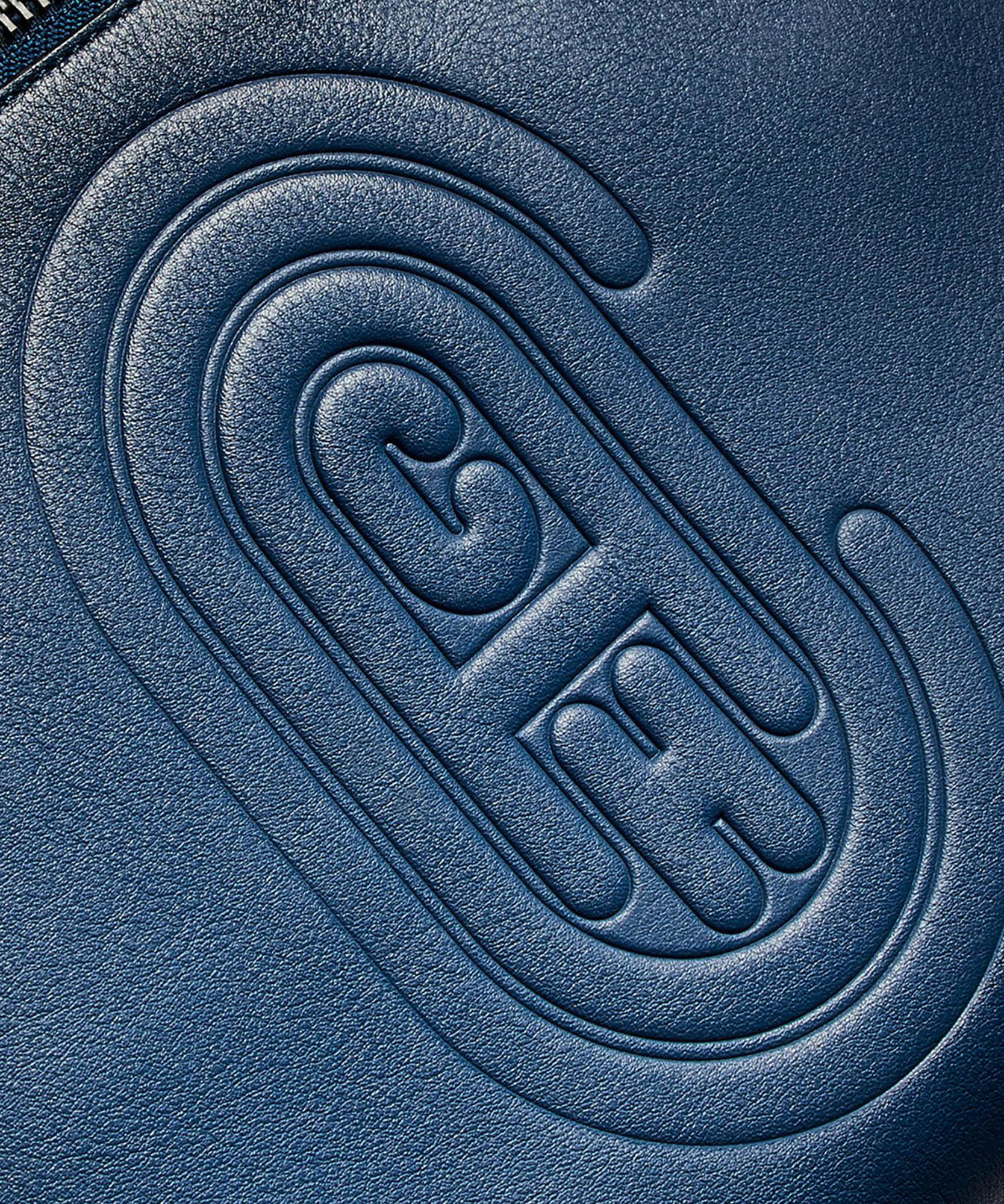 photo of coach logo imprinted on leather