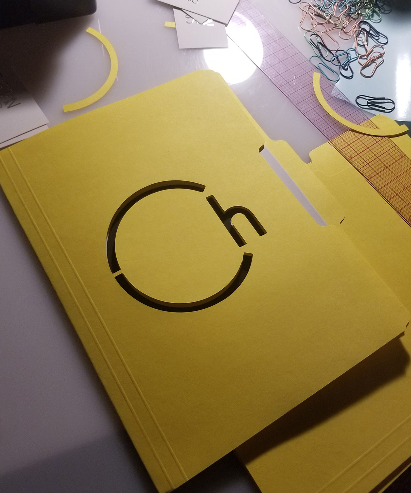 Christian L harris logo cut out on yellow folder 