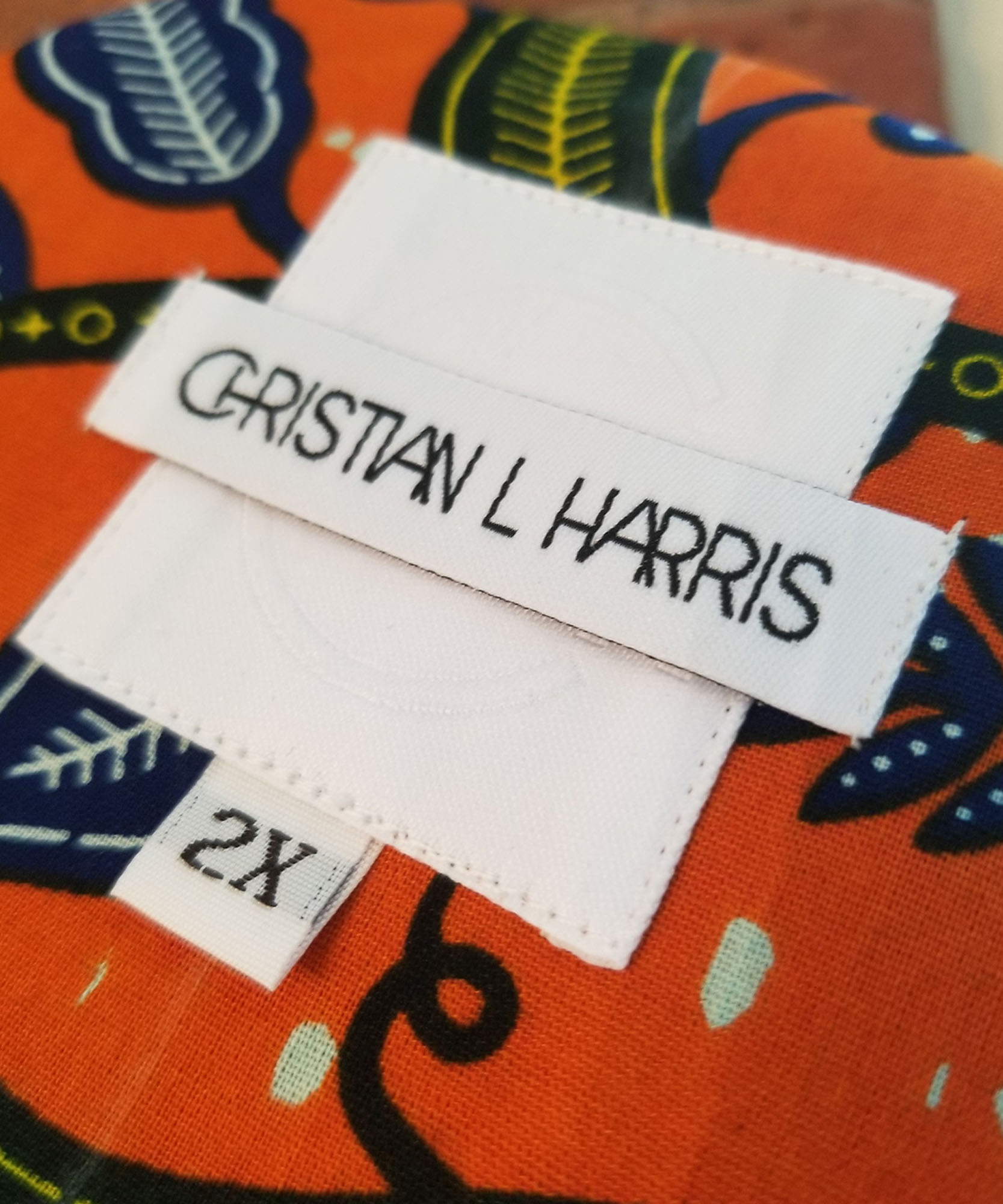 Christian L harris logo on tag inside orange shirt