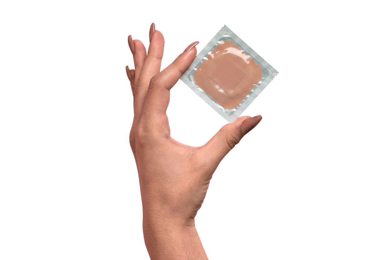 Hand holding a birth control patch