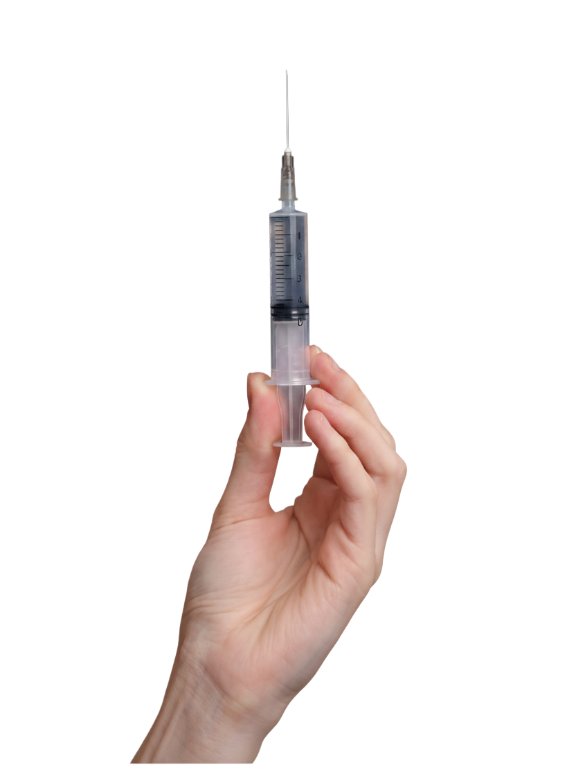 Hand holding a birth control shot syringe