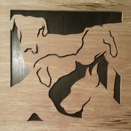 Silhouettes of four Great Danes hand cut from Birchwood.