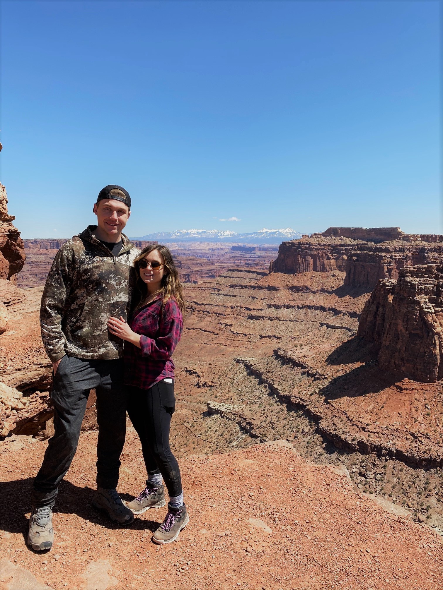 picture of Suz and her boyfriend Dan on top of a canyon in Moab, Utah