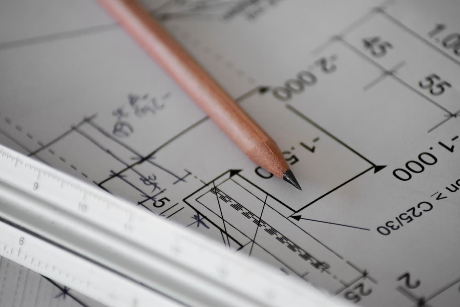 architect plans and drawings with a pencil