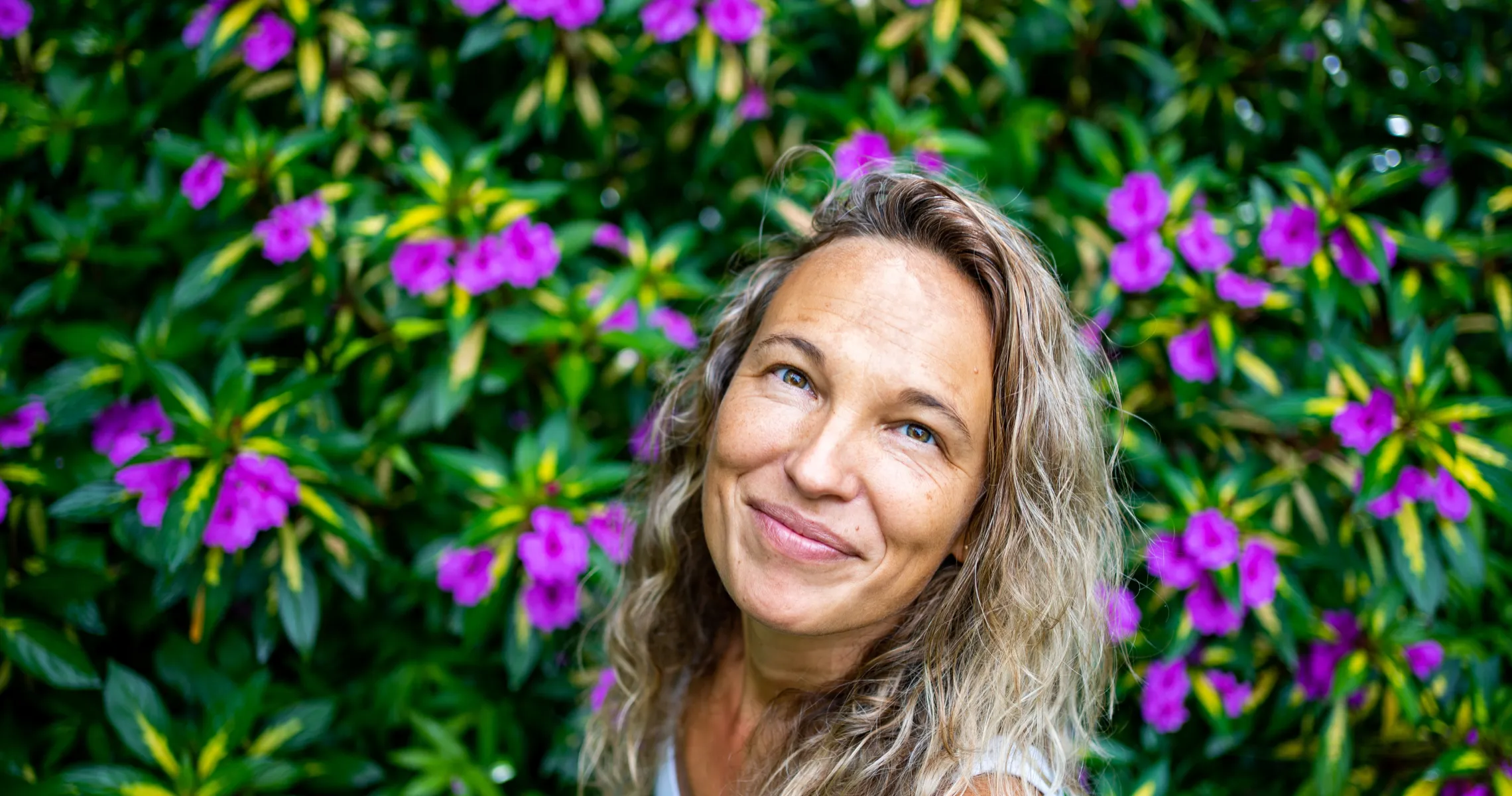 mushroomtao founder leti smiling in front of flowers