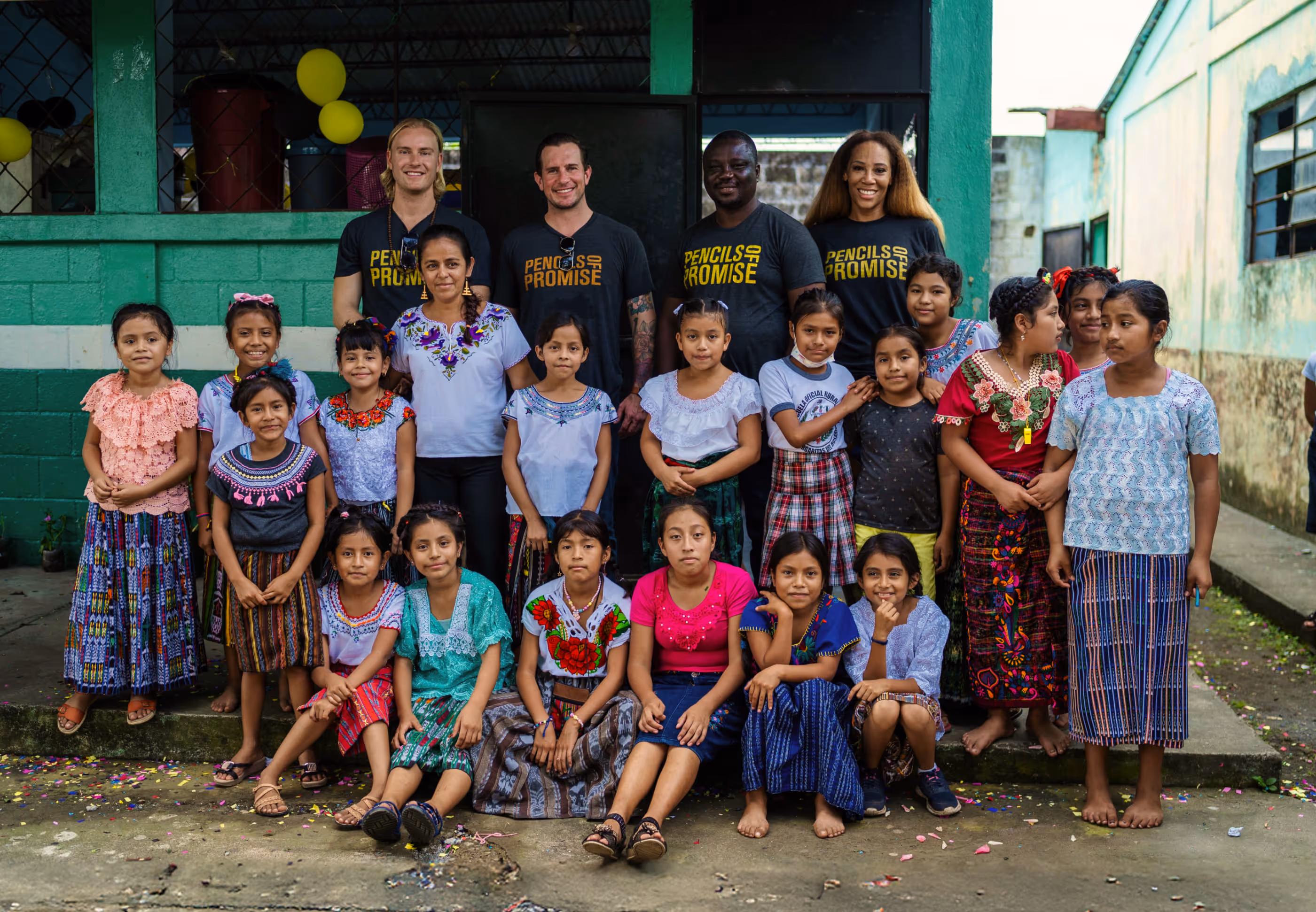 Group photo of Pencils of Promise team members with children