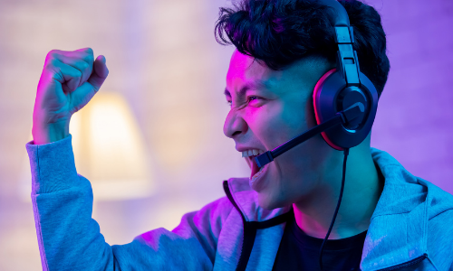 An excited gamer celebrating an achievement during a game play session.