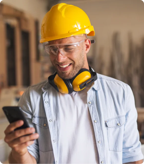 portrait of construction manager using phone on job site
