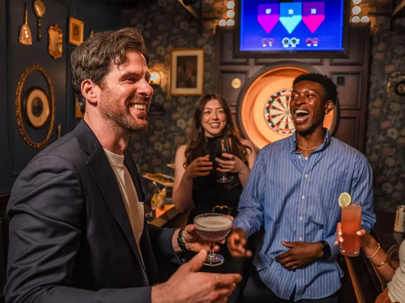 Group of people having fun playing darts