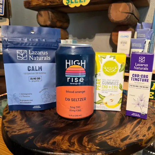 A grouping of 4 CBD products including Lazarus Naturals CBD gummies, High Rise Beverage Co. Blood Orange D9 Seltzer, WYLD CBD+CBG Gummies, and Lazarus Naturals CBD:CBD Tincture