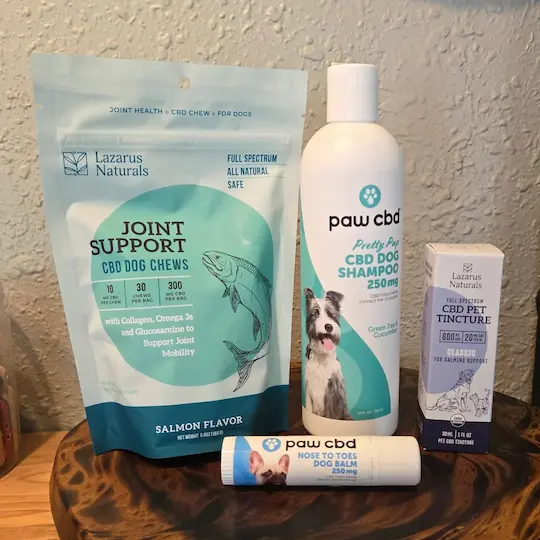 A grouping of 4 pet CBD products including Lazarus Naturals Joint Support CBD Dog Chews, Paw CBD Dog Shampoo, Paw CBD Nose to Toes Dog Balm, and Lazarus Naturals CBD Pet Tincture