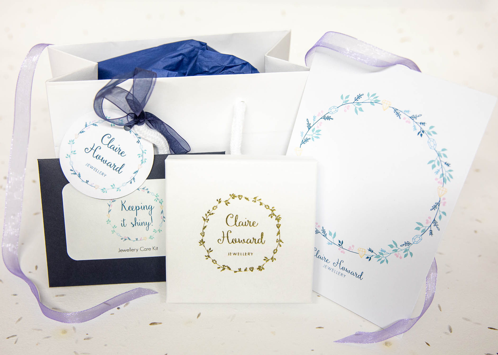 gift wrapping from Claire Howard Jewellery including white jewellery box tied with ribbon, gift bag and tag, polishing cloth kit and gift card