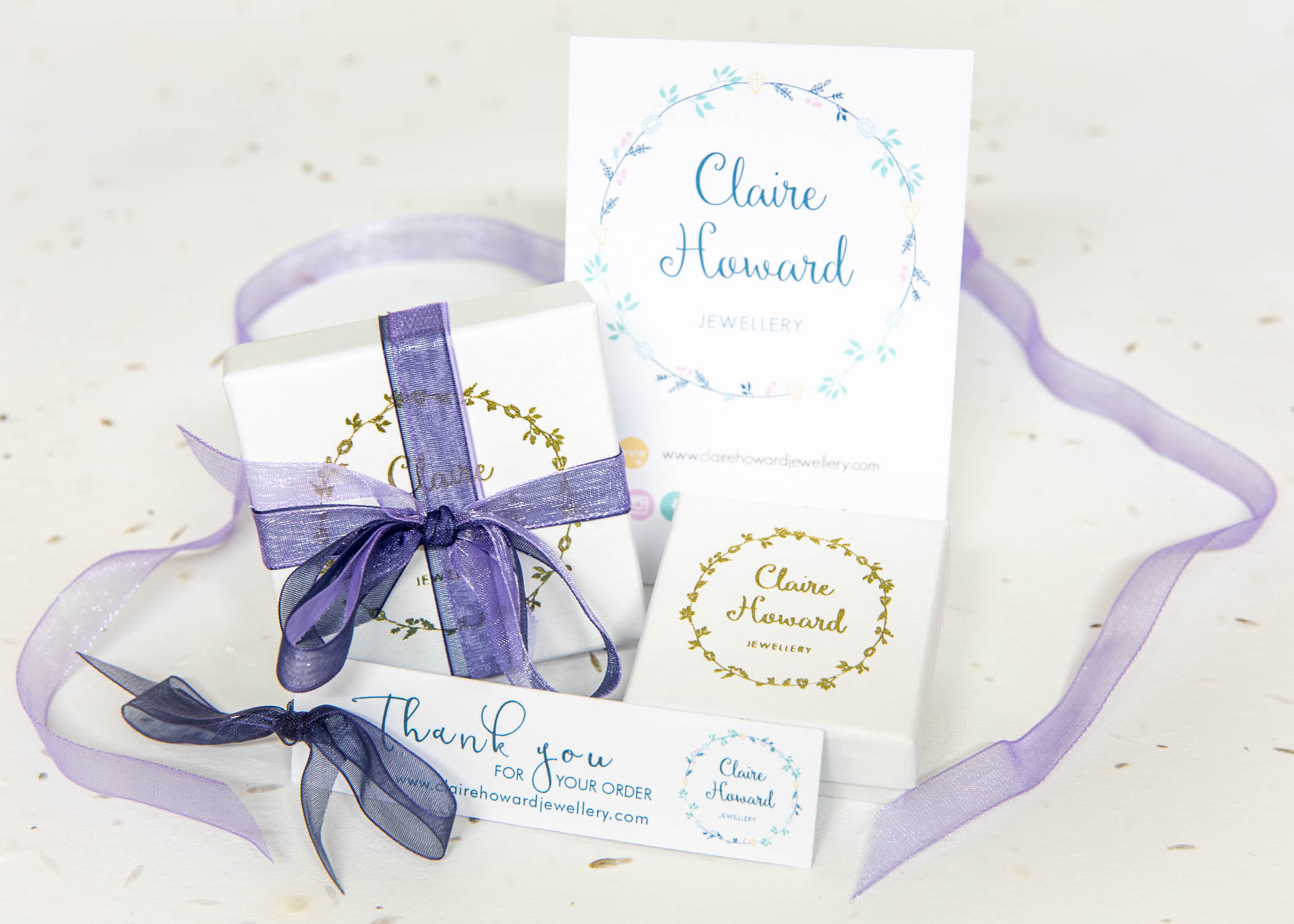 gift wrapping from Claire Howard Jewellery showing white jewellery box, thank you card and care label