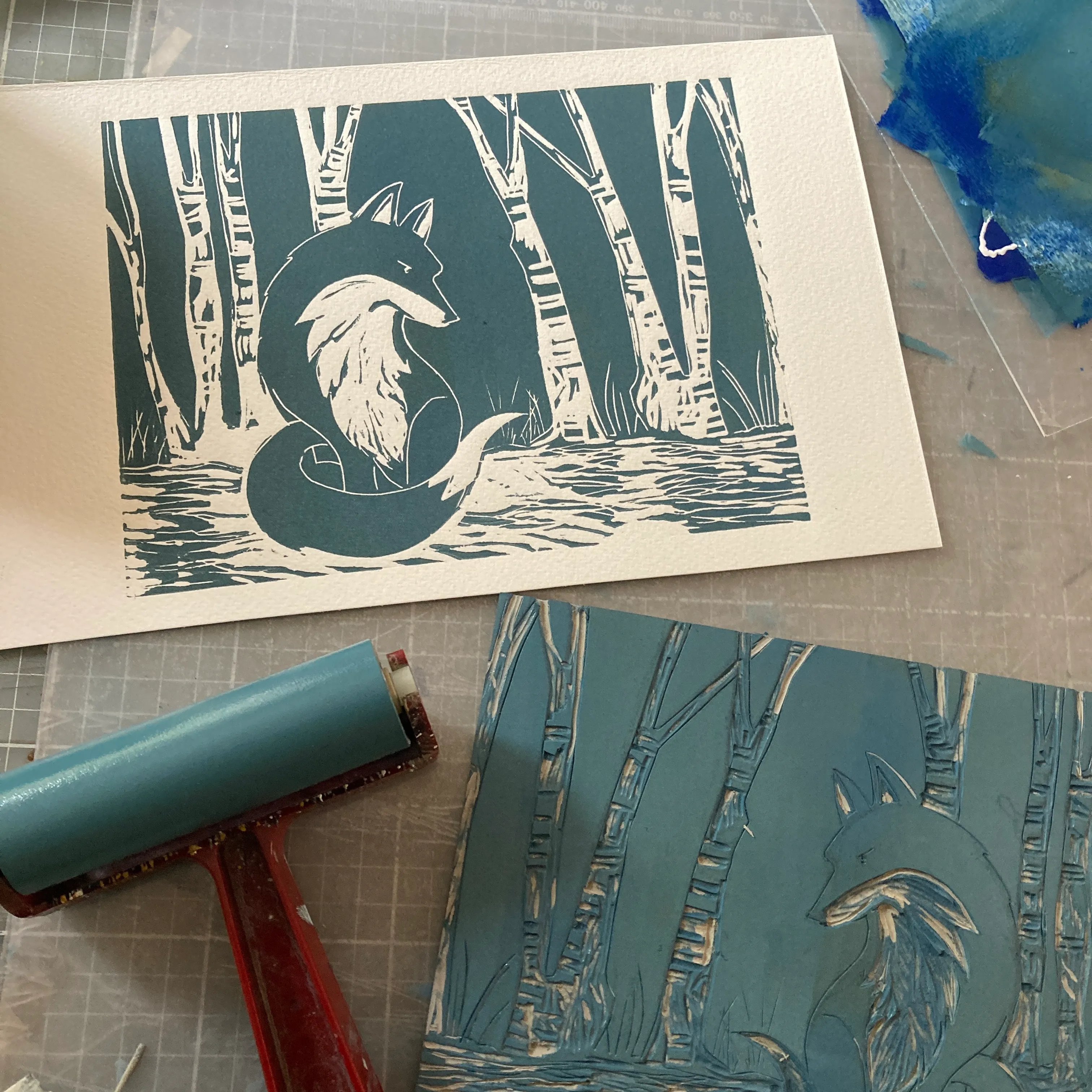 linocut of fox and specialist roller with lino cut board in foreground