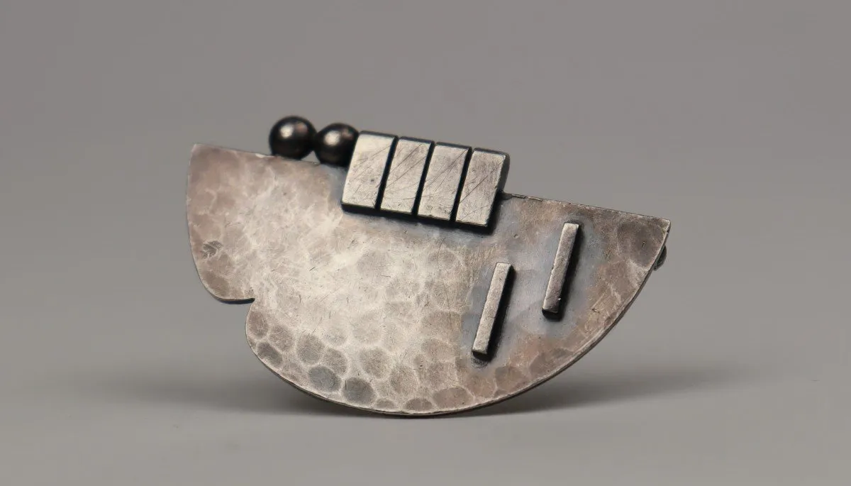 Silver propeller brooch by Jean Dupres