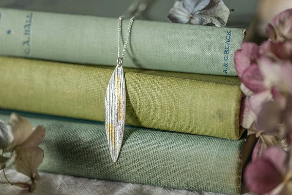 Sterling silver willow leaf necklace with 24k gold, applied using the ancient Korean Keum Boo technique. Handmade in Norfolk and gift wrapped—perfect for nature lovers.