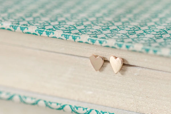 Tiny golden heart studs on sterling silver posts with butterfly scrolls—perfect for saying thank you or as a sweet birthday treat for a friend or mum.