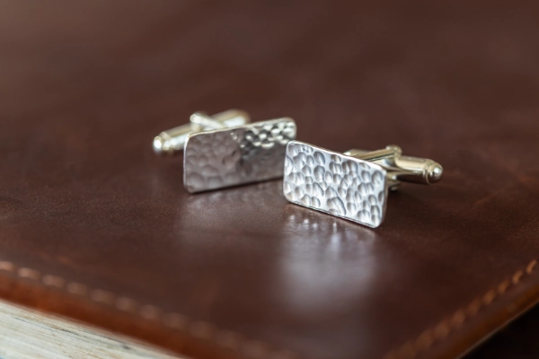 Handmade sterling silver cufflinks with a rugged, hammered finish—meaningful men’s jewellery inspired by strength, simplicity, and Norfolk heritage.